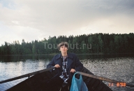По финскому озерцу в финской лодке финскими веслами мой муж Дима гребет к финскому необитаемому острову.