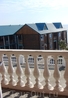 Вид с террасы на деревянный корпус  гостиницы "Новинка"
