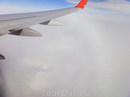 Вторая интересная фотография, сделанная в полете - это появление гало (оптическое явление - круговая радуга) под крылом самолета и отражение в нем этого ...
